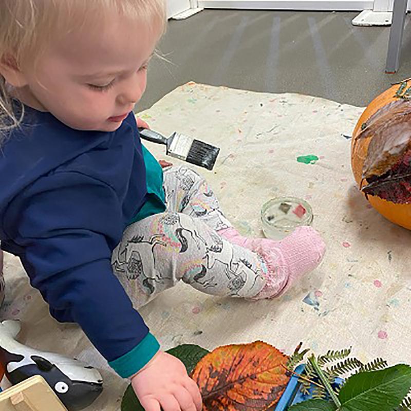 Toddler painting at nursery