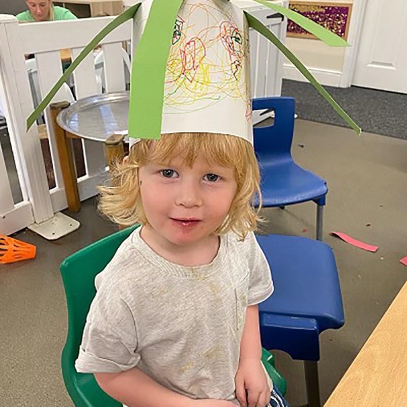 Girl at nursery wearing a paper crown