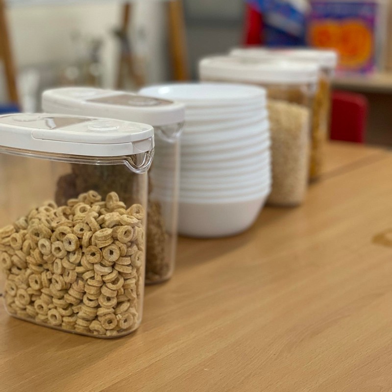 Breakfast cereals in containers on a table