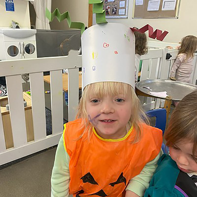 Girl at nursery wearing a paper crown